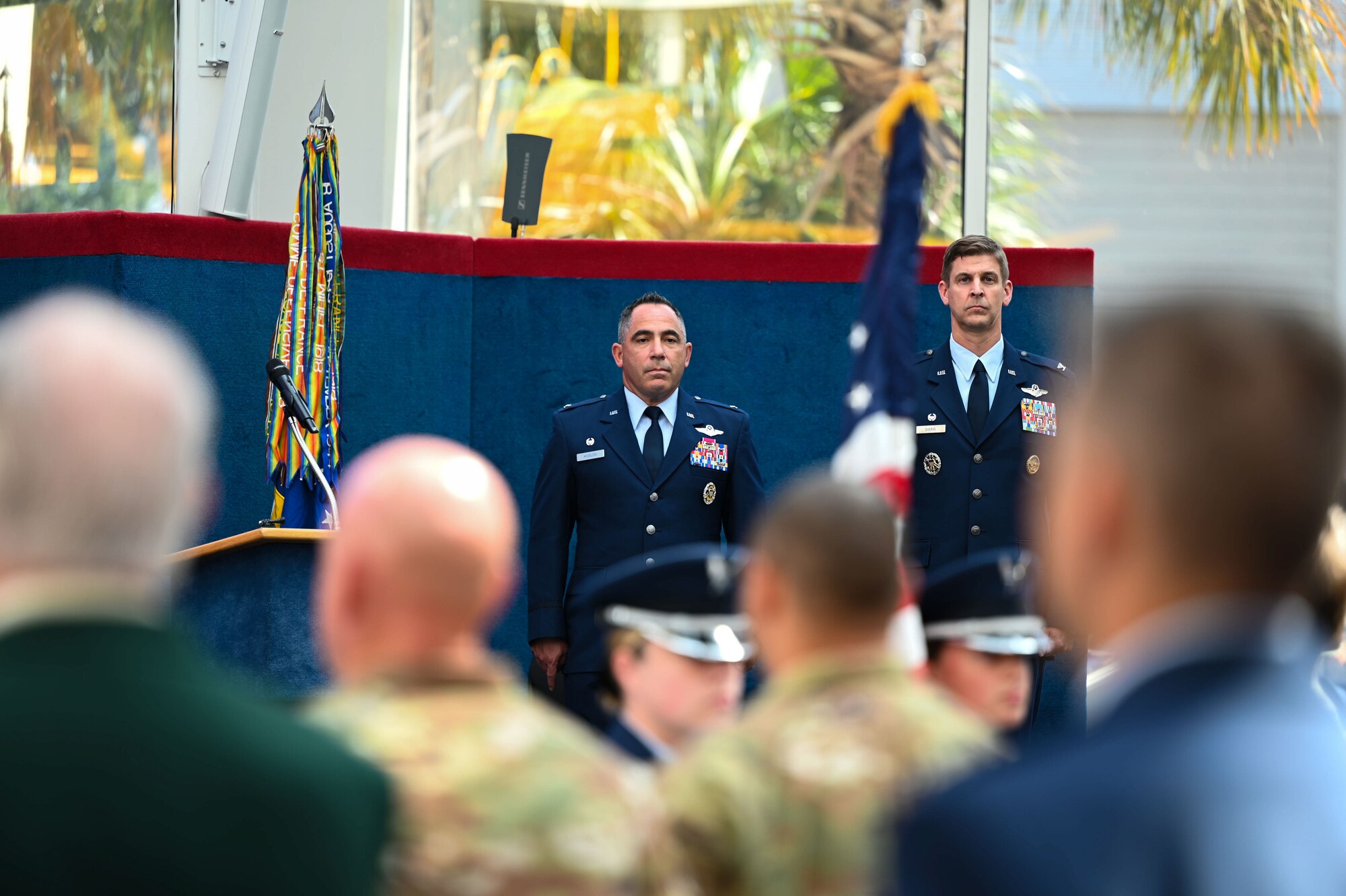 U.S. Air Force Col. Josh Koslov, 350th Spectrum Warfare Wing commander, left, and U.S. Air Force Col. Patrick Dierig, 479th Flying Training Group commander, right, stand at attention during the presentation of the Colors during the Undergraduate Combat Systems Officer Training graduation at the National Naval Aviation Museum, Naval Air Station Pensacola, Fla., Aug. 25, 2023. Koslov was invited as the keynote speaker during the graduation ceremony. (U.S. Air Force photo by Capt. Benjamin Aronson)