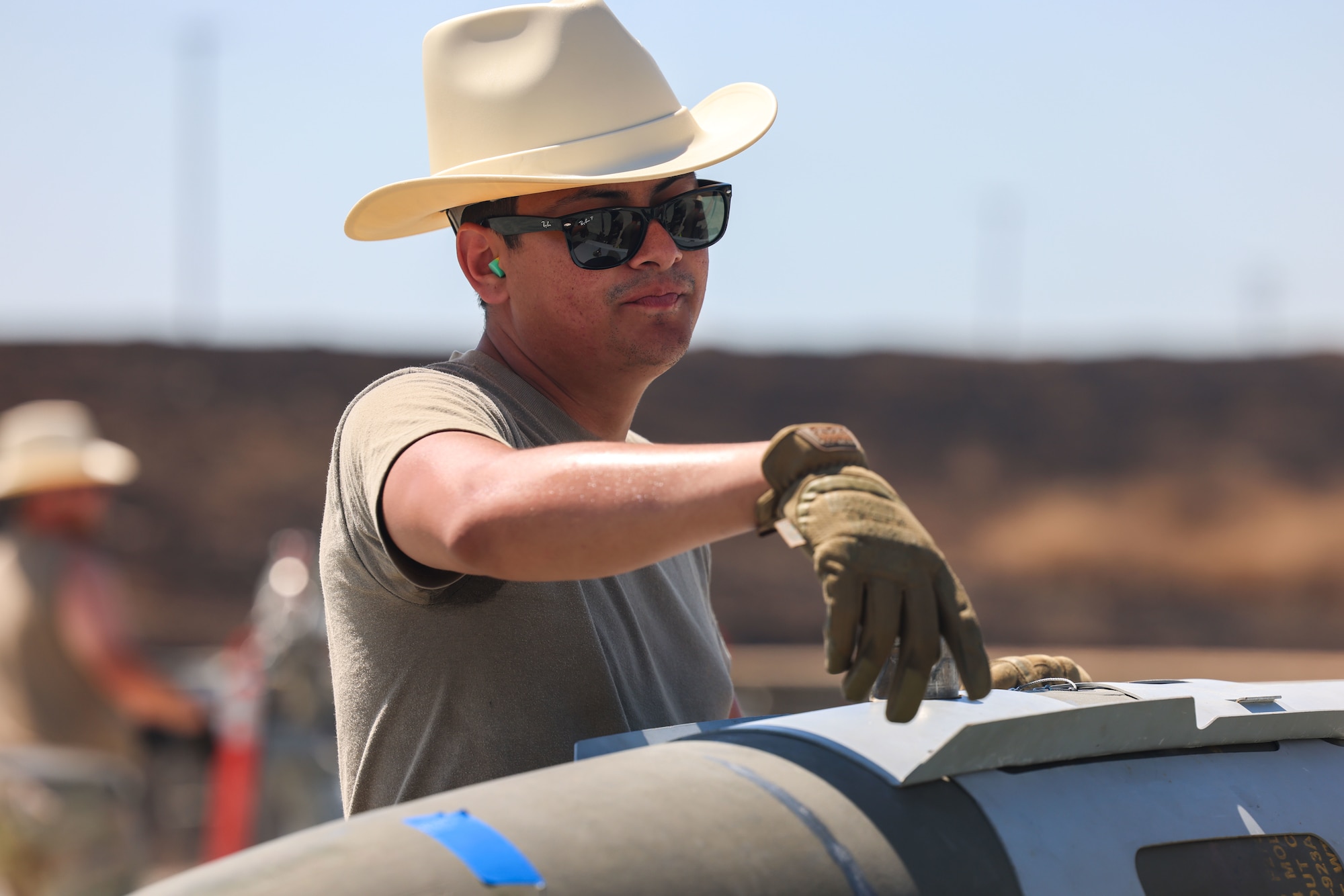 U.S. Air Force Senior Airman Nicolas Gonzales, 56th Equipment Maintenance Squadron stockpile maintenance crew chief, from Luke Air Force Base, Arizona, inspects a bomb on a trailer during the Air Force Combat Operations Competition (AFCOCOMP) on Beale Air Force Base, California, Aug. 24, 2023.