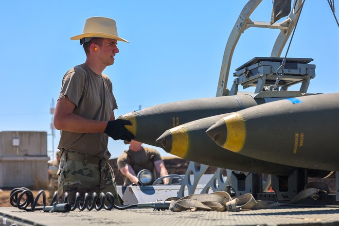 U.S. Air Force Staff Sgt. Benjamin Petro, 56th Equipment Maintenance Squadron trailer maintenance crew chief, from Luke Air Force Base, Arizona, loads a bomb onto a trailer during the Air Force Combat Operations Competition (AFCOCOMP) on Beale AFB, California, Aug. 24, 2023.