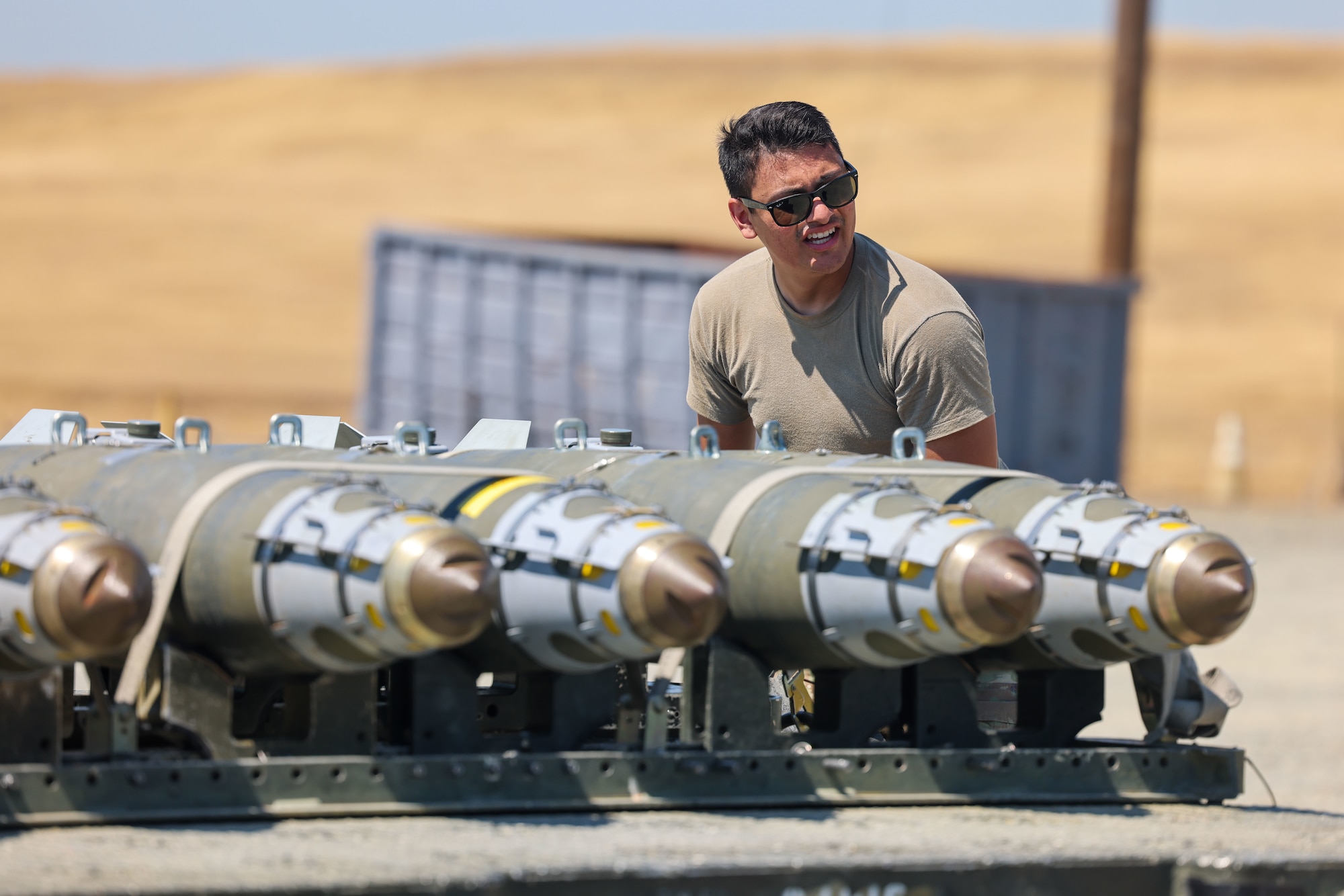 U.S. Air Force Senior Airman Nicolas Gonzales, 56th Equipment Maintenance Squadron stockpile maintenance crew chief, from Luke Air Force Base, Arizona, performs a foreign object debris check before simulating transporting bombs to the flight line during the Air Force Combat Operations Competition (AFCOCOMP) on Beale AFB, California, Aug. 24, 2023.