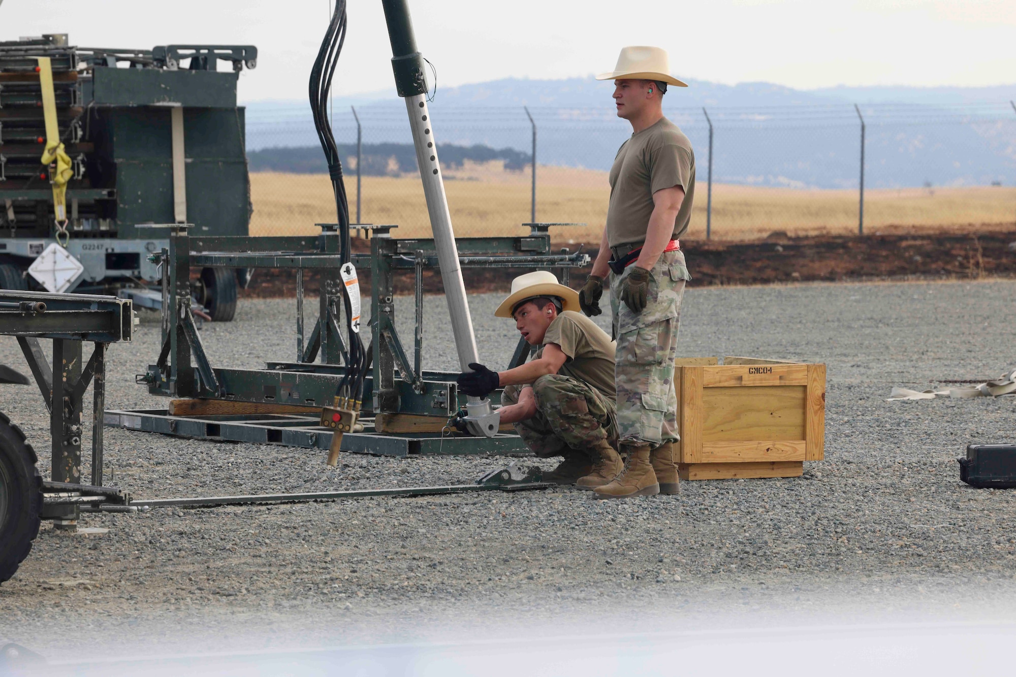U.S. Air Force Airmen from Luke Air Force Base, Arizona, 56th Equipment Maintenance Squadron munitions flight, build a munitions assembly conveyer while competing in the Air Force Combat Operations Competition, Aug. 22, 2023, at Beale AFB, California.