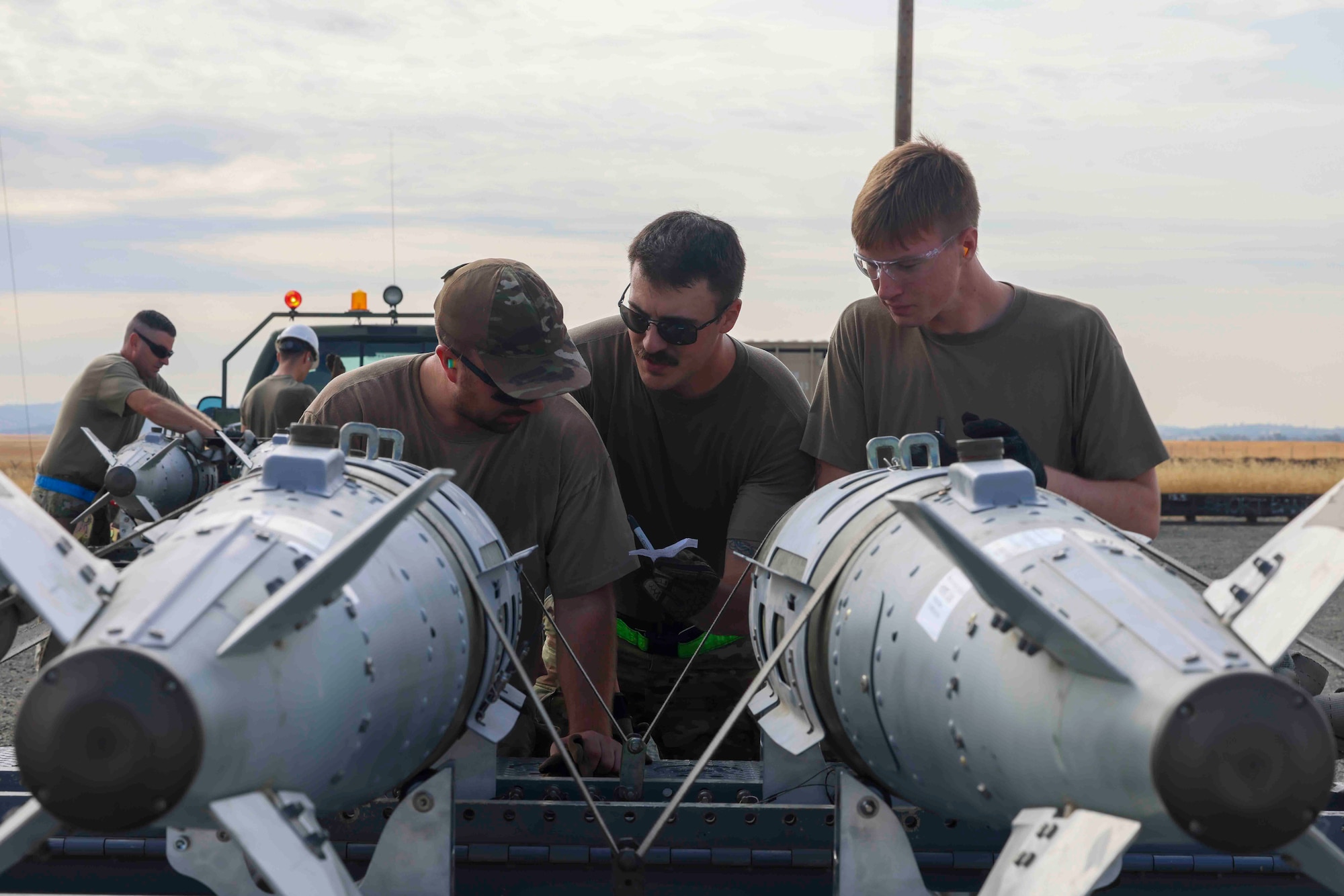 U.S. Air Force Airmen from Whiteman Air Force Base, Missouri, 509th Munitions Squadron, conduct a trailer build of GBU-32 munitions while competing in the Air Force Combat Operations Competition, Aug. 22, 2023, at Beale AFB, California.