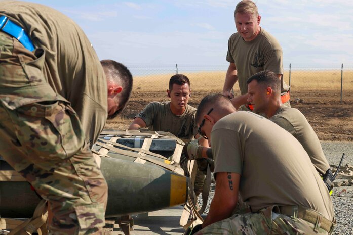 U.S. Air Force Airmen from Shaw Air Force Base, S.C., 20th Equipment Maintenance Squadron, build a cargo palette to load munitions during the Air Force Combat Operations Competition, Aug. 22, 2023, at Beale AFB, California.