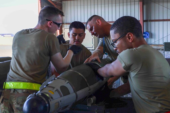 U.S. Air Force Airmen from Whiteman Air Force Base, Missouri, 509th Munitions Squadron, build GBU-54 munitions as part of an event during the Air Force Combat Operations Competition, Aug. 23, 2023, at Beale AFB, California.