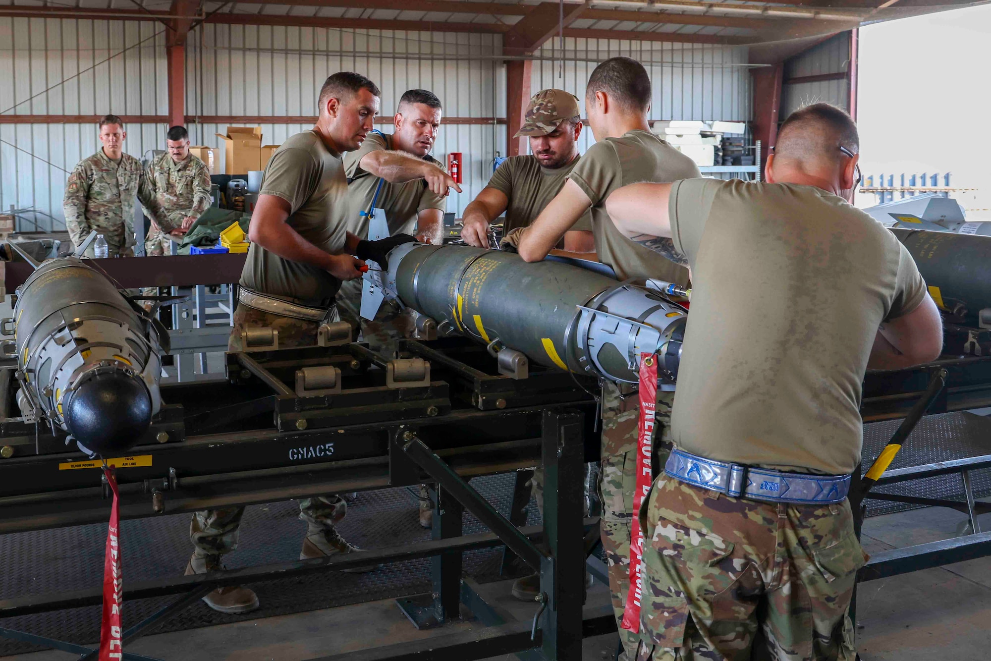 U.S. Air Force Airmen from Whiteman Air Force Base, Missouri, 509th Munitions Squadron, build GBU-54 munitions using the munitions assembly conveyer during the Air Force Combat Operations Competition, Aug. 23, 2023, at Beale AFB, California.