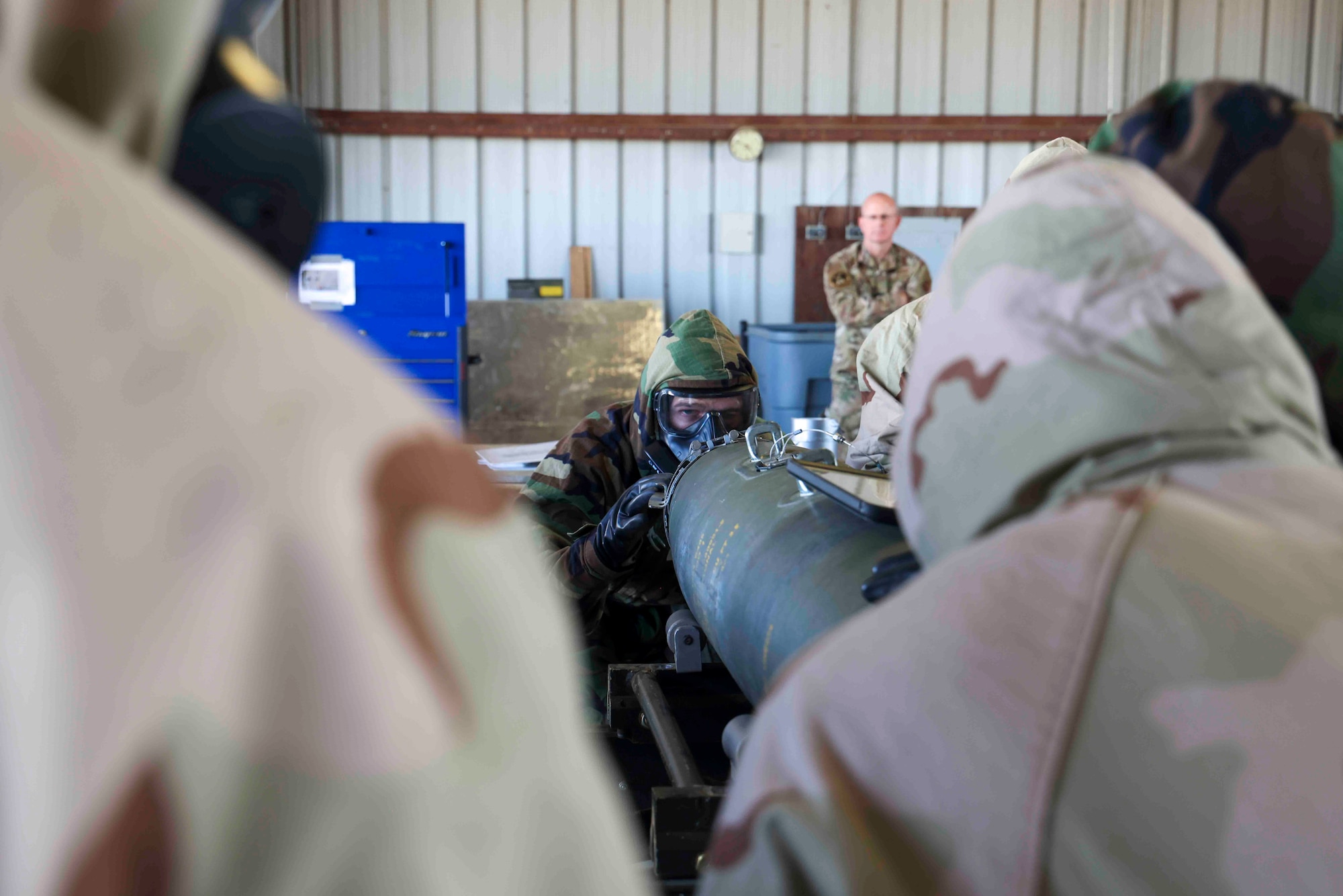 U.S. Air Force Airmen from Whiteman Air Force Base, Missouri, 509th Munitions Squadron, build GBU-54 munitions in MOPP gear to simulate continuing warfighting capabilities in the event of a CBRN attack during the Air Force Combat Operations Competition (AFCOCOMP), Aug. 23, 2023, at Beale AFB, California.