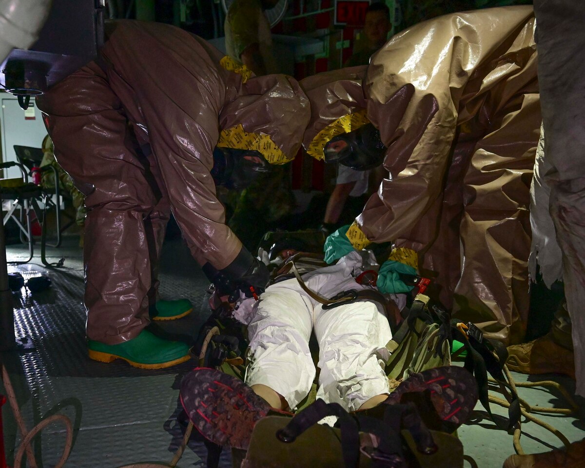 U.S. Air Force Senior Airman Jessica Ashwell, left, and Airman Lydia Schubert, right, 355th Civil Engineer Squadron emergency management technicians, perform decontamination and cut-out procedures for rescue victims during a training at the Titan Missile Museum in Green Valley, Ariz., Aug. 22, 2023. Victims from the contaminated location went through the decontamination station before they were medically evacuated. (U.S. Air Force photo by Staff Sgt. Nicholas Ross)