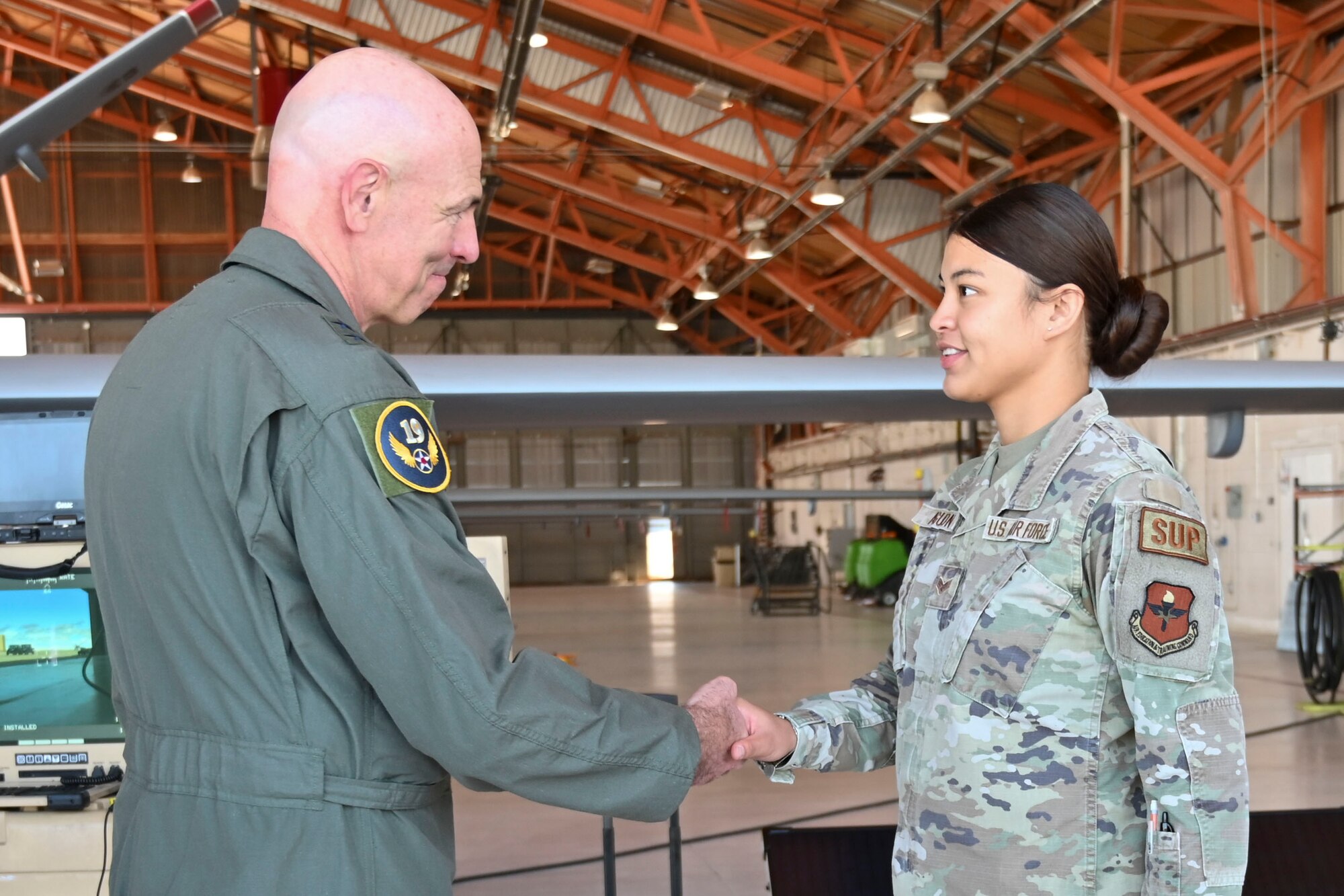 U.S. Air Force Maj. Gen. Clark Quinn, 19th Air Force commander, coins U.S. Air Force Senior Airman Jenna Aguon, 49th Logistics Readiness Squadron phase decentralized material section technician, at Holloman Air Force Base, New Mexico, Aug. 24, 2023.
