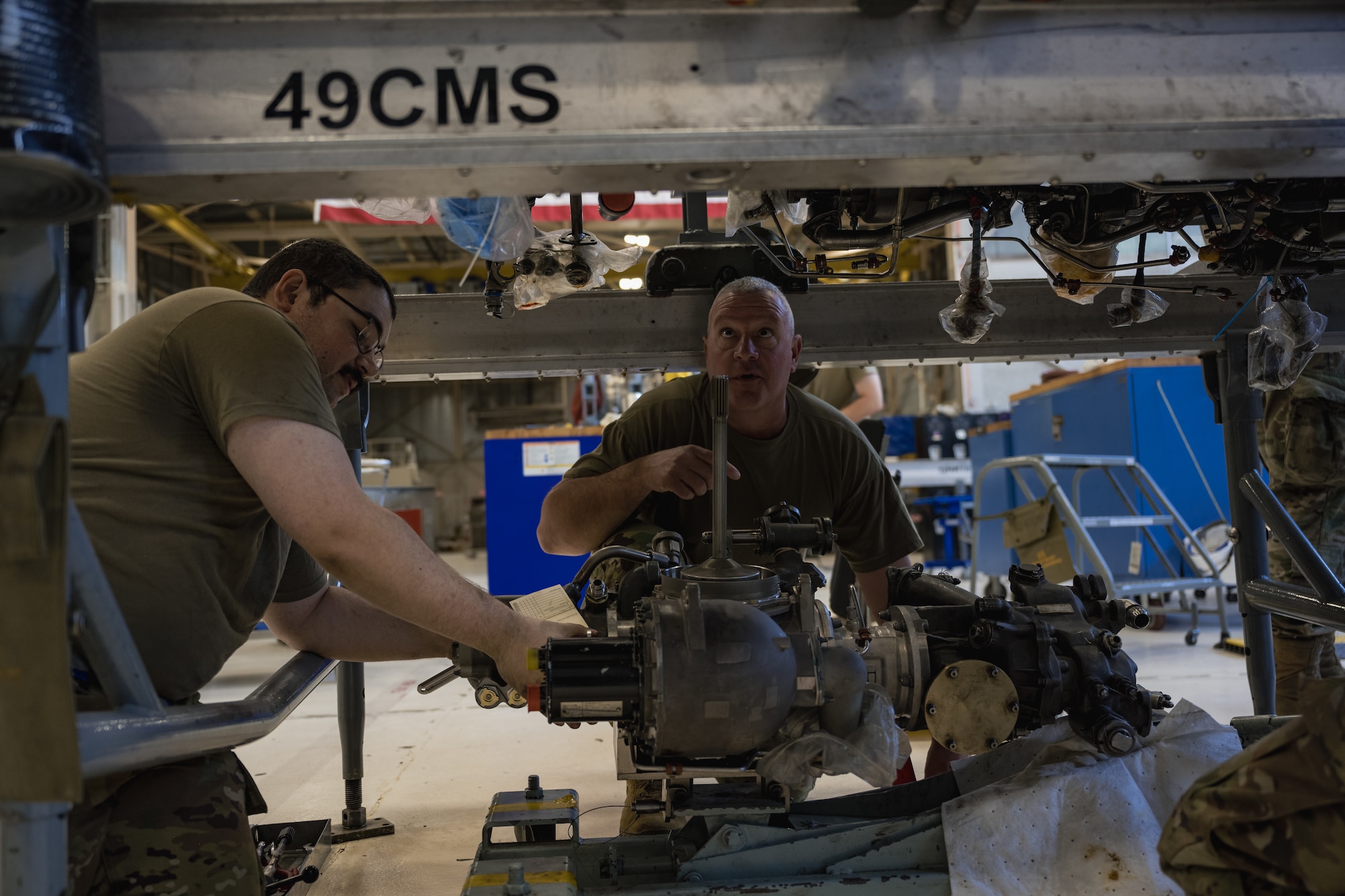 U.S. Air Force Chief Master Sgt. Justin Apticar, 19th Air Force command chief, prepares to install an F-16 Viper engine with Airmen from the 49th Component Maintenance Squadron propulsion flight at Holloman Air Force Base, New Mexico, Aug. 22. 2023.