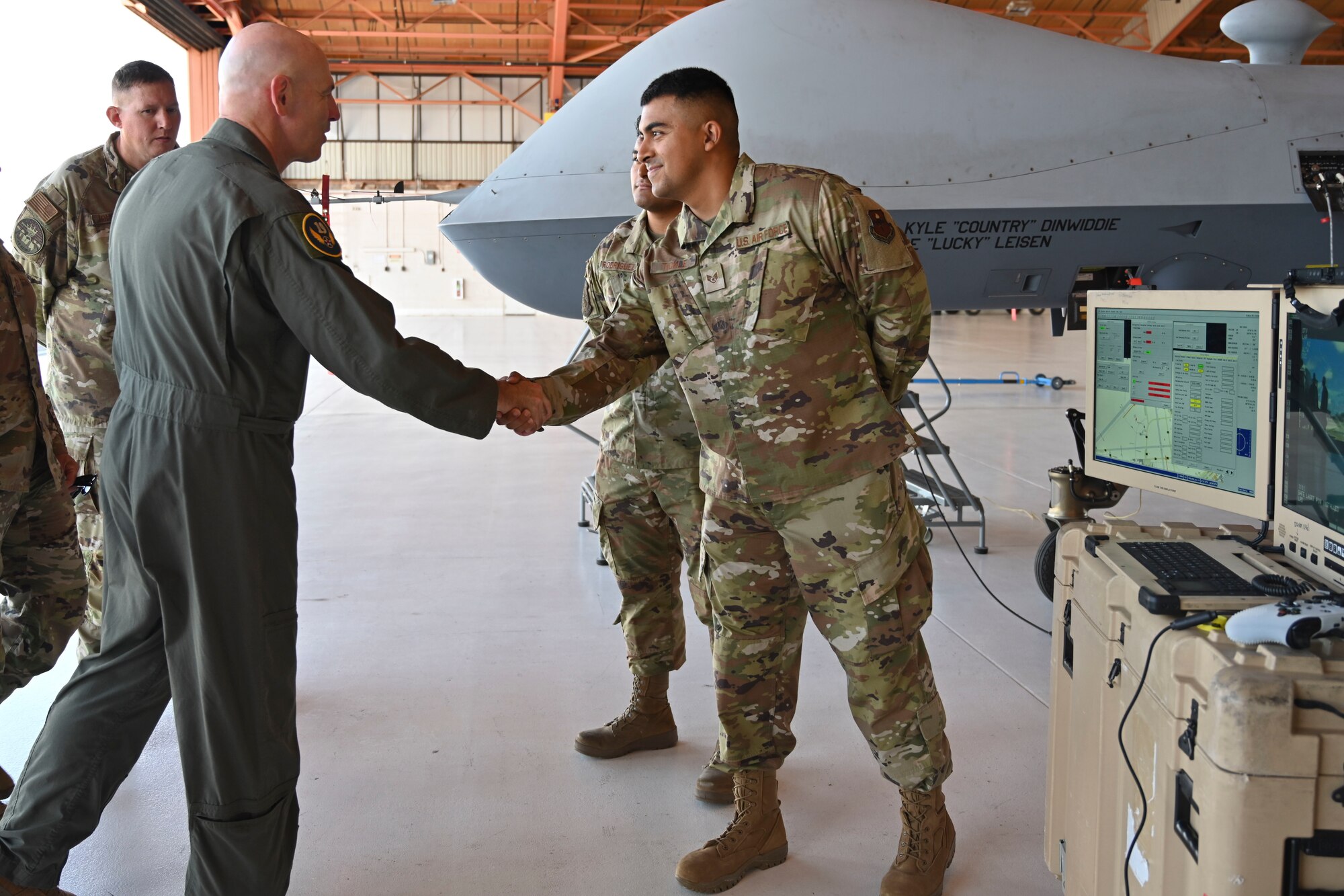 U.S. Air Force Maj. Gen. Clark Quinn, 19th Air Force commander, greets U.S. Air Force Staff Sgt. Jack Tickle, 49th Aircraft Maintenance Squadron dedicated crew chief, before learning about MQ-9 Reaper maintenance operations at Holloman Air Force Base, New Mexico, Aug. 24, 2023.