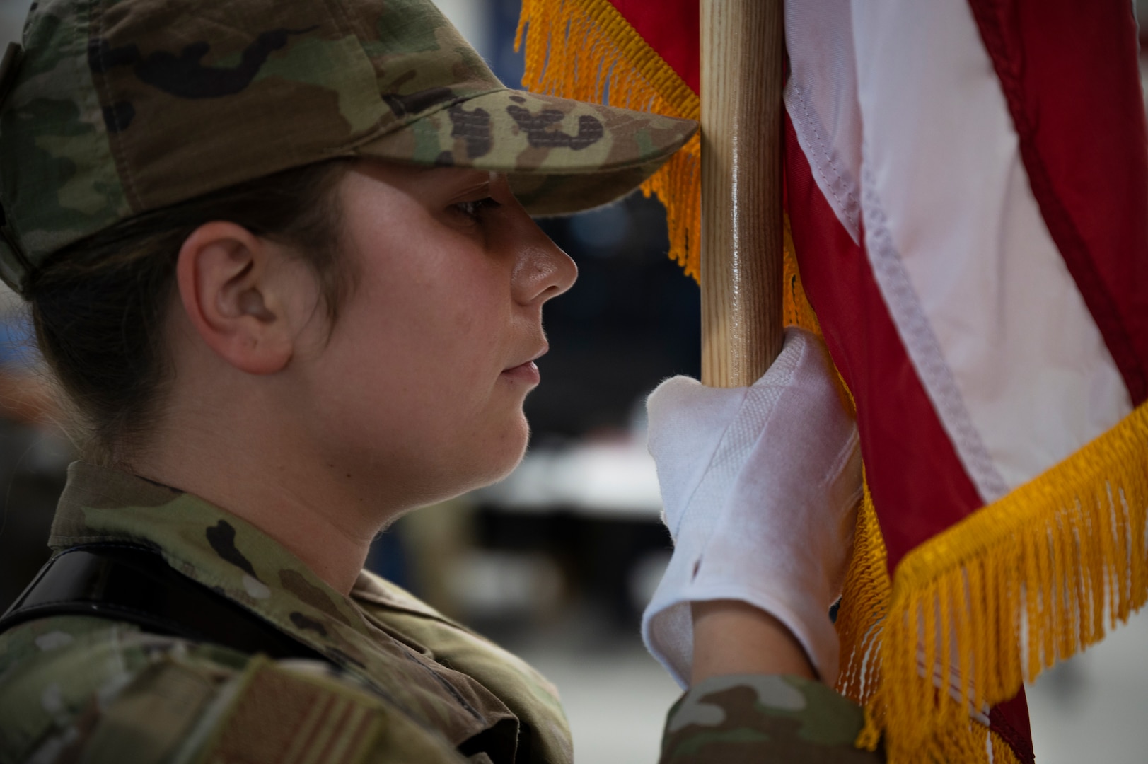 The side profile of a woman in military uniform is shown.