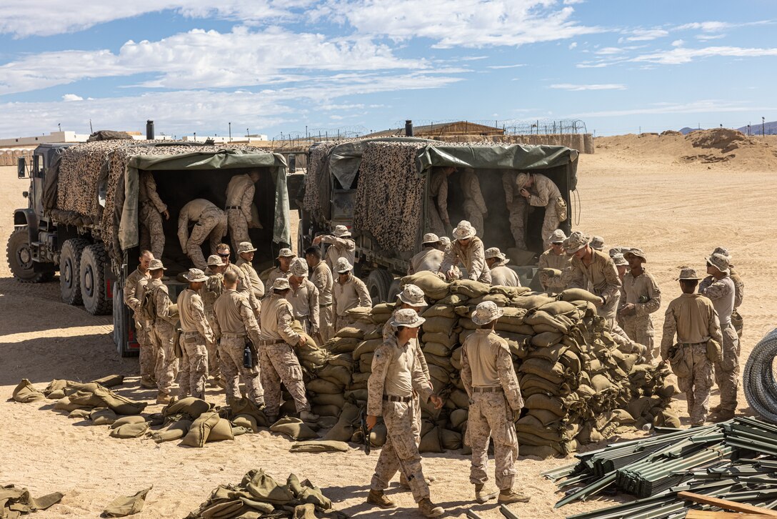 U.S. Marines with 3rd Battalion, 7th Marine Regiment, load sandbags onto a truck during Adversary Force Exercise 5-23 at Marine Corps Air-Ground Combat Center, Twentynine Palms, California, Aug. 9, 2023. AFX 5-23 tested the skills of Marines in seizing and maintaining a combat presence in urban environments by training in offensive and defensive tactics, conducing logistics in a contested environment, and utilizing mechanized infantry.