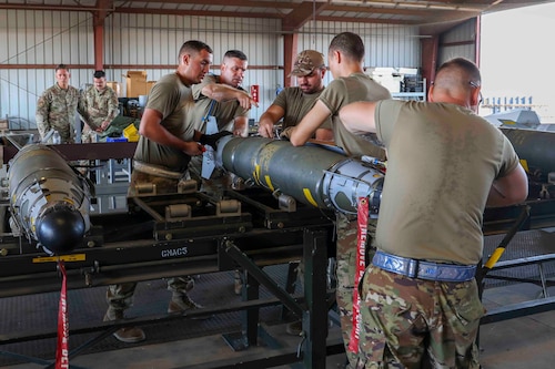 U.S. Air Force Airmen from Whiteman Air Force Base, Missouri, 509th Munitions Squadron, build GBU-54 munitions using the munitions assembly conveyer during the Air Force Combat Operations Competition, Aug. 23, 2023, at Beale AFB, California.