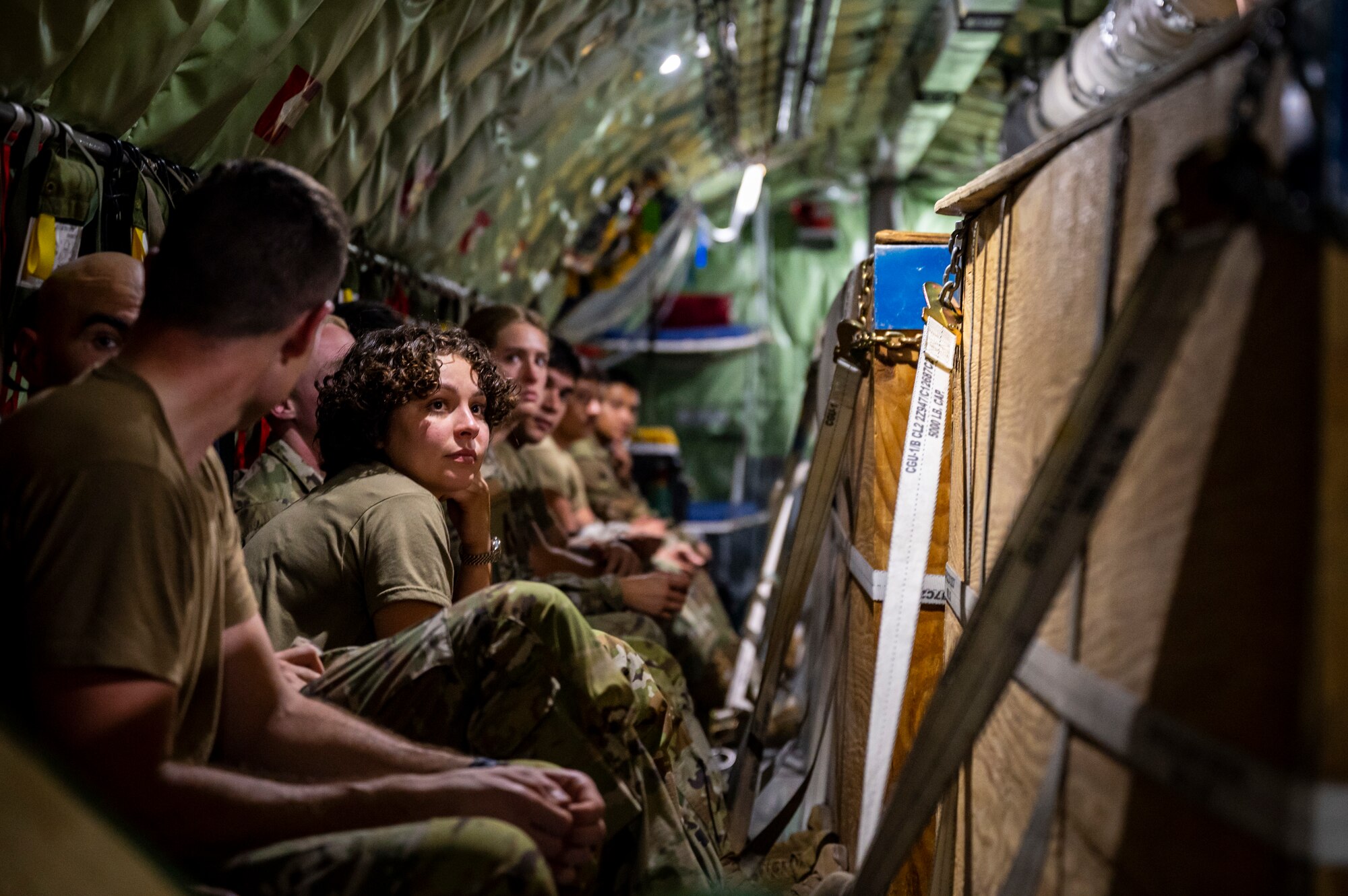 Service members sitting in an aircraft