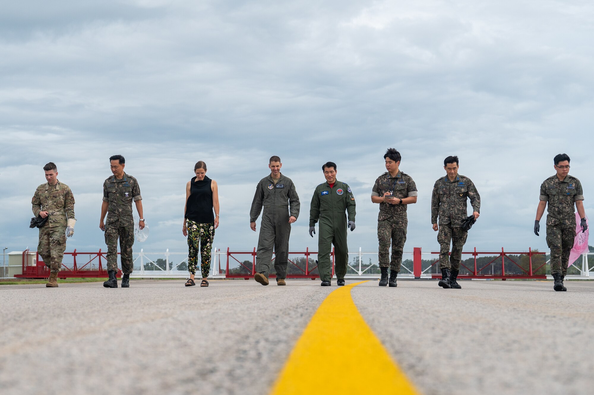 U.S. Air Force 8th Fighter Wing members and Republic of Korea Air Force 38th Fighter Group members conduct a joint foreign object debris walk.