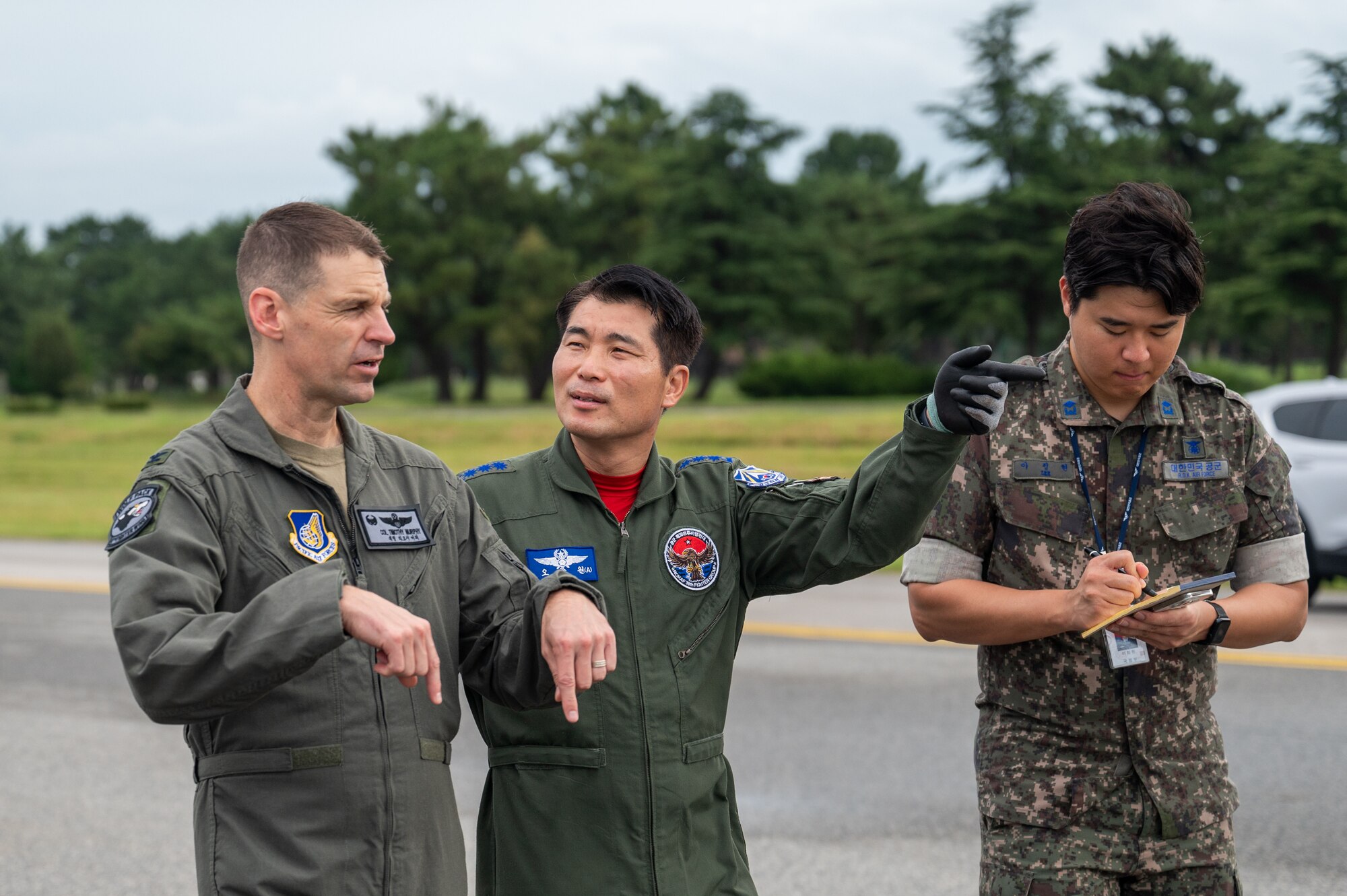 U.S. Air Force Col. Timothy B. Murphy and Republic of Korea Air Force Col. Choong-Won Oh discuss operations during a joint foreign object debris walk.