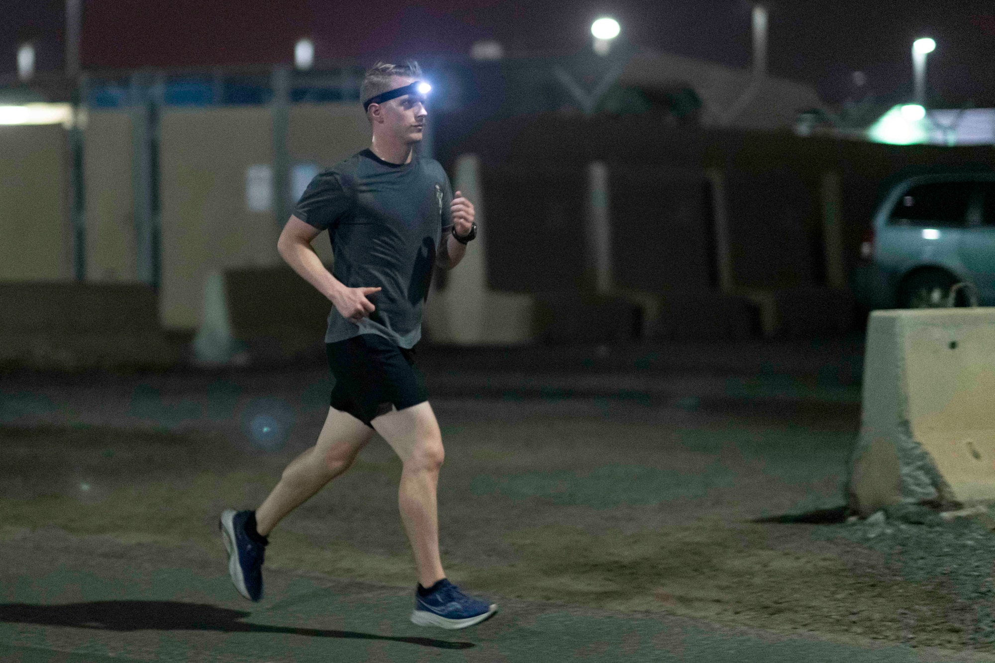 Photo of a man running on a road at night