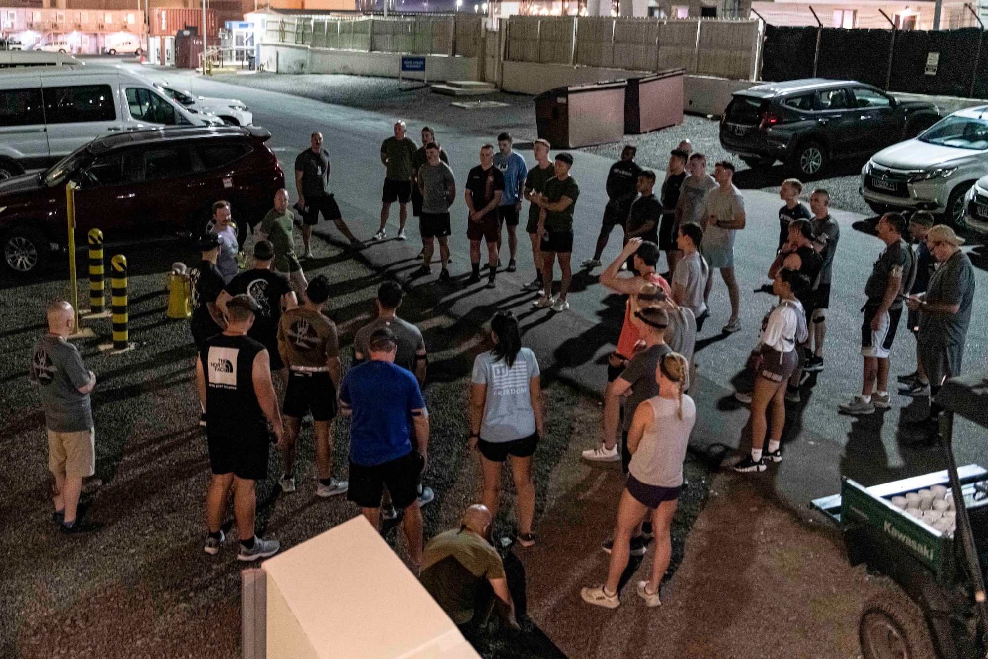 Photo of runners gathered by a road at night