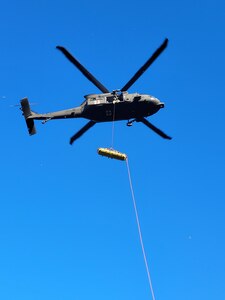 A Wyoming Army National Guard helicopter crew, working with local agencies, executes a daring aerial evacuation during a challenging 24-hour rescue mission of two climbers in Box Elder Canyon, Converse County, on Aug. 15, 2023.