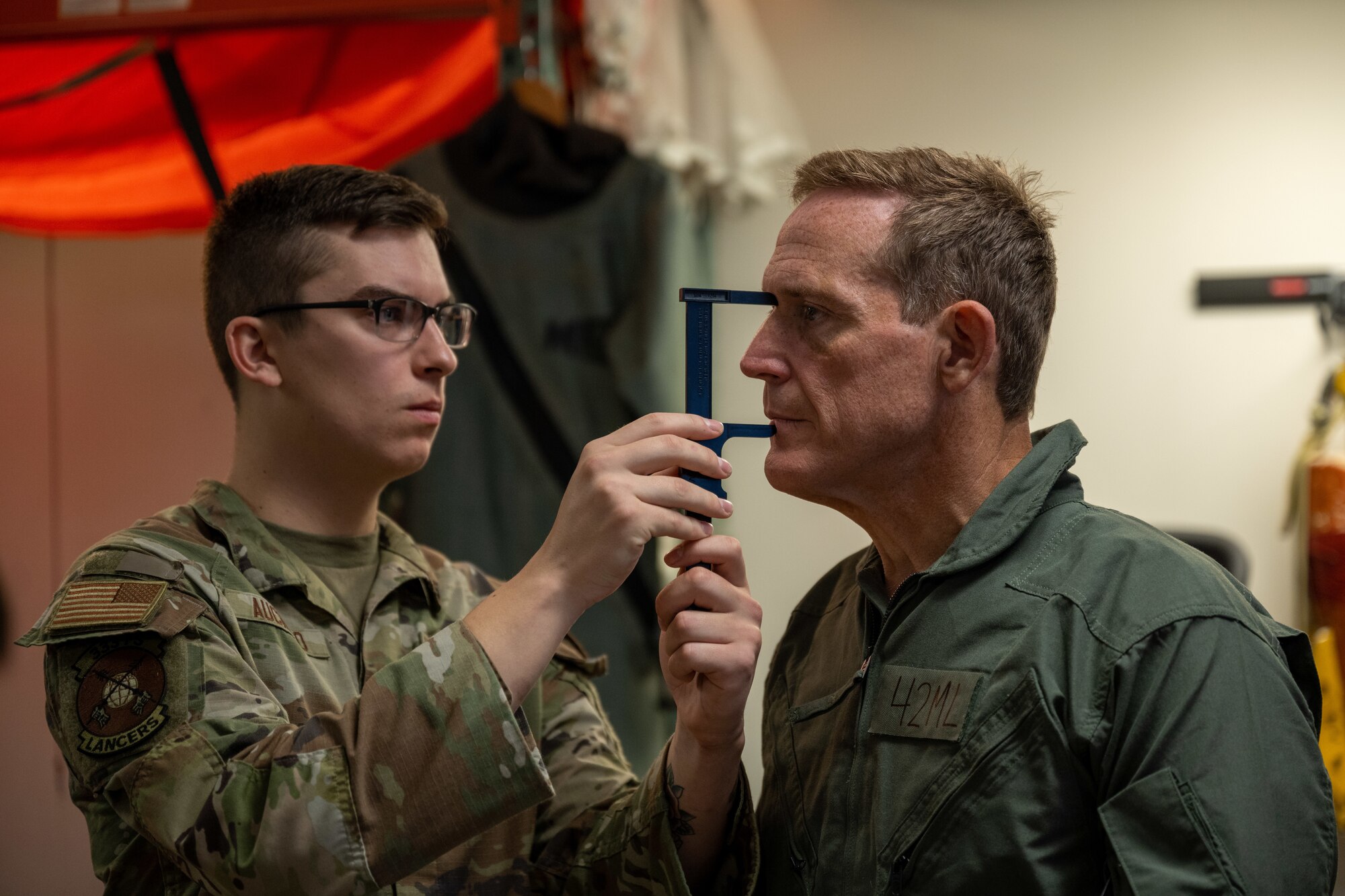 Airman 1st Class Anthony Auciello, left, 333rd Fighter Squadron aircrew flight equipment technician, measures Ted Budd, North Carolina Senator, for a helmet during Budd’s visit at Seymour Johnson Air Force Base, North Carolina, Aug. 18, 2023. While Budd visited he was fitted for flight equipment, received a flight physical and participated in an F-15E Strike Eagle incentive flight. (U.S. Air Force photo by Senior Airman David Lynn)