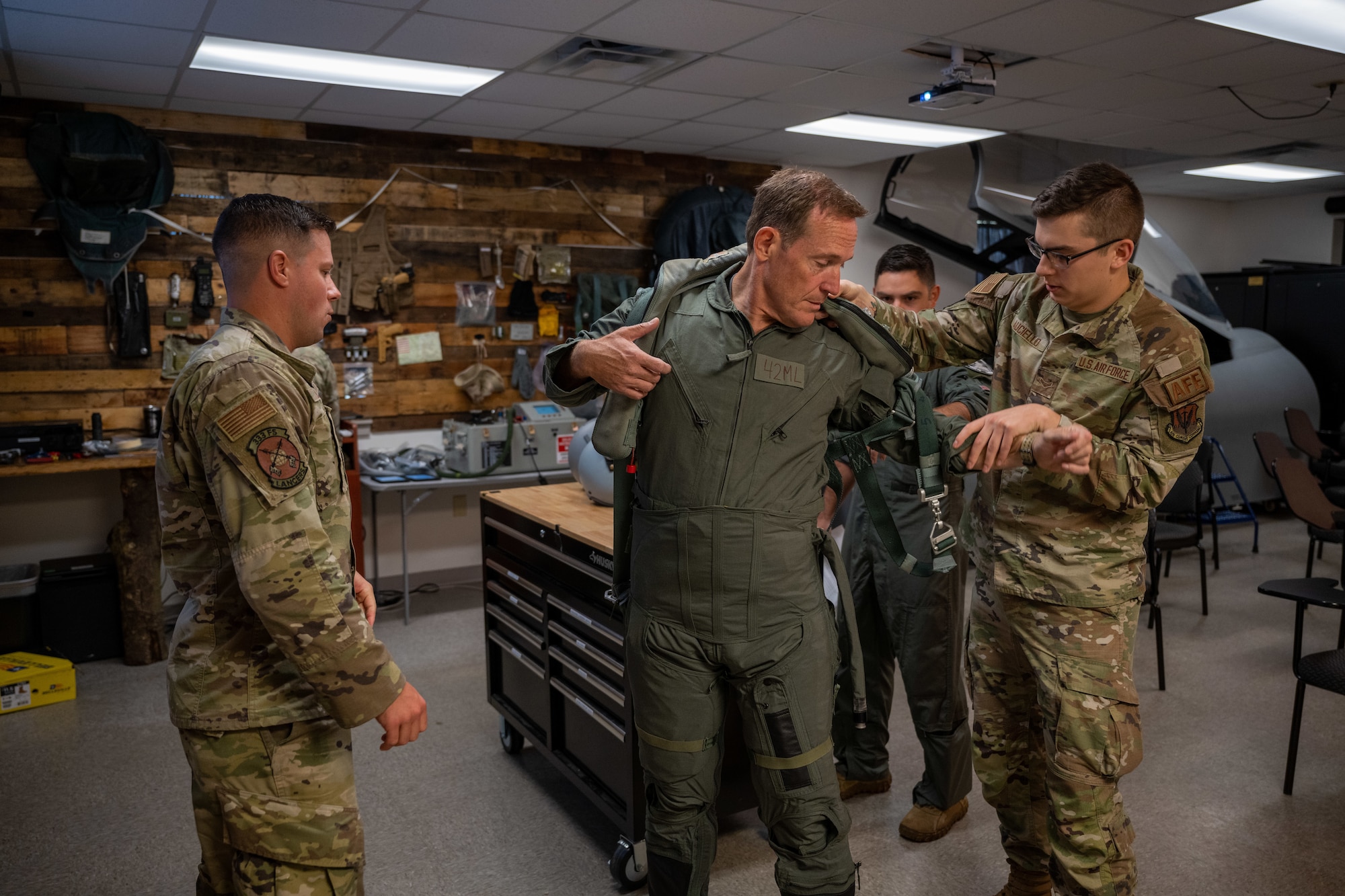 Ted Budd, center, North Carolina Senator, gets fitted for flight equipment during a visit at Seymour Johnson Air Force Base, North Carolina, Aug. 18, 2023. While Budd visited he was fitted for flight equipment, received a flight physical and participated in an F-15E Strike Eagle incentive flight. (U.S. Air Force photo by Senior Airman David Lynn)