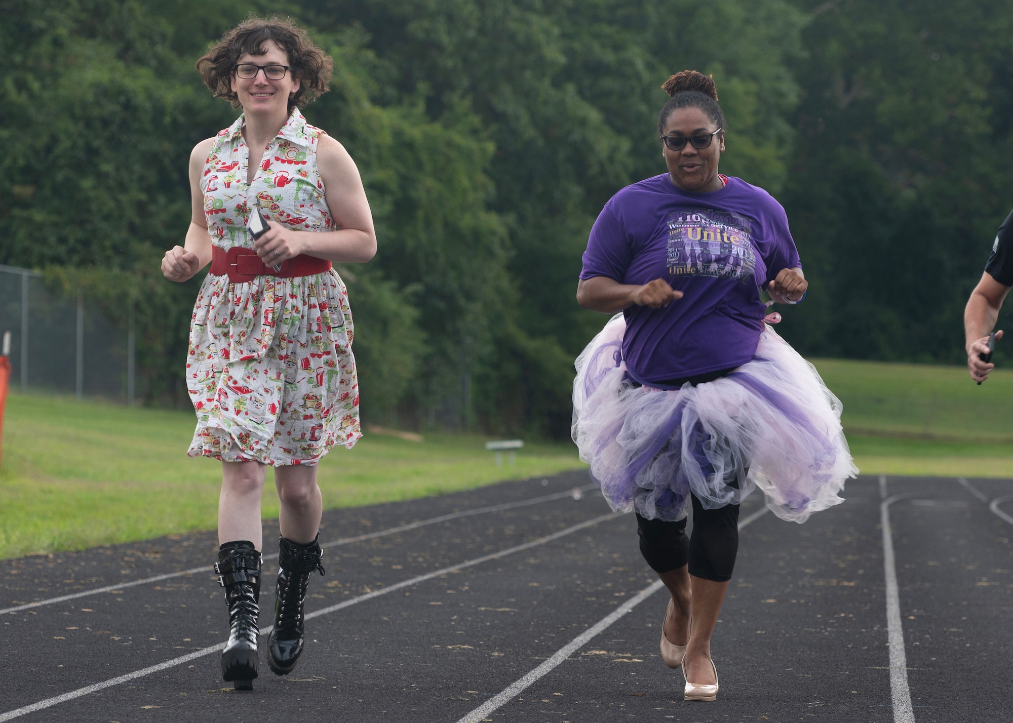 Two women run on a track