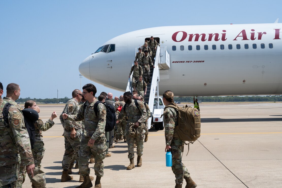 Friends and co-workers greet the 2nd Bomb Wing Airmen returning from Andersen Air Force Base, Guam after returning from a Bomber Task Force mission.