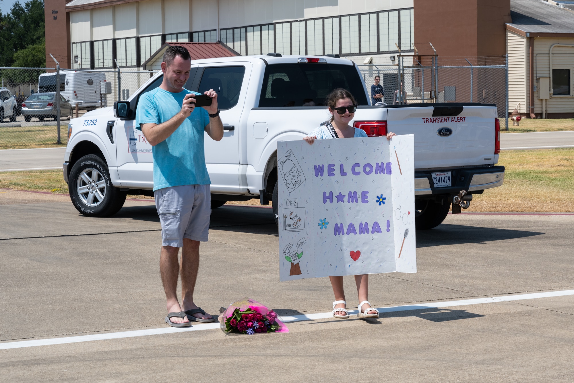 A daughter and husband await the return of their Airmen after a deployment in support of the Bomber Task Force mission at Barksdale Air Force Base, La.
