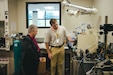 Two people looking at science equipment.