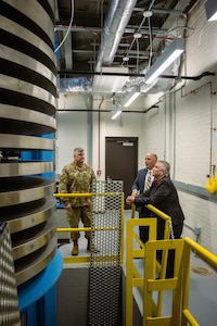 People looking at a giant scale.