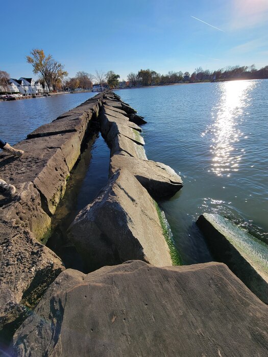 Stone pier surrounded by water.