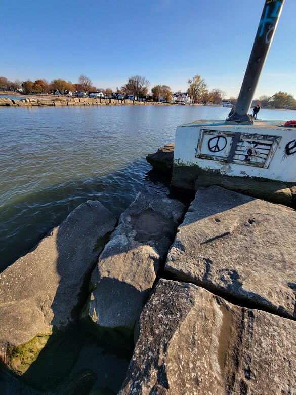 Stone pier surrounded by water.