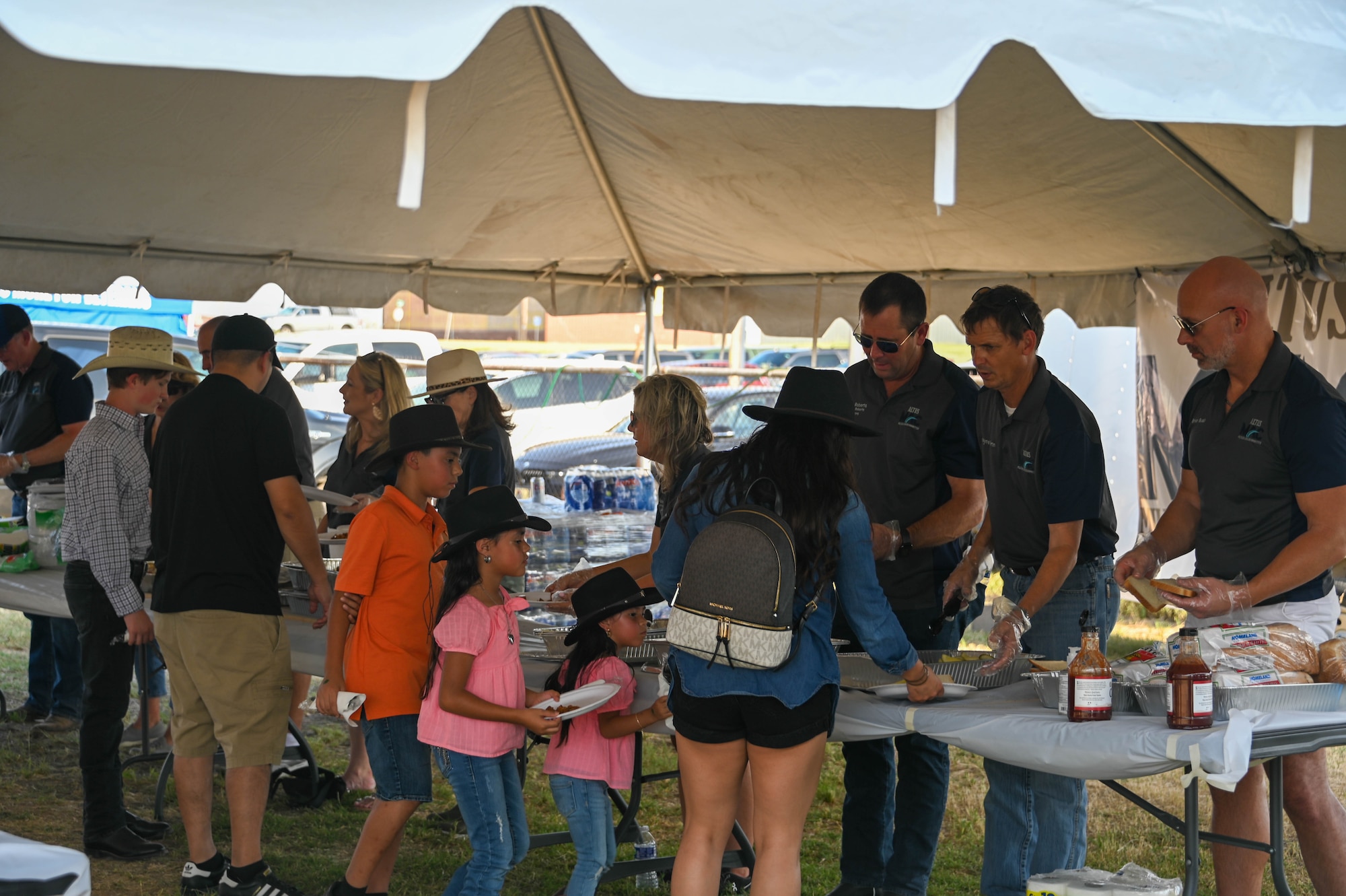Members of the Altus Military Affairs Committee serve food to Airmen and their families during the Military Appreciation Night dinner at the Great Plains Stampede Rodeo in Altus, Oklahoma, Aug. 24, 2023. The dinner was held to show appreciation for the Airmen’s dedication and service. (U.S. Air Force photo by Airman 1st Class Heidi Bucins)