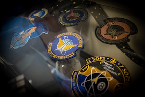 Military patches in a display cabinet.