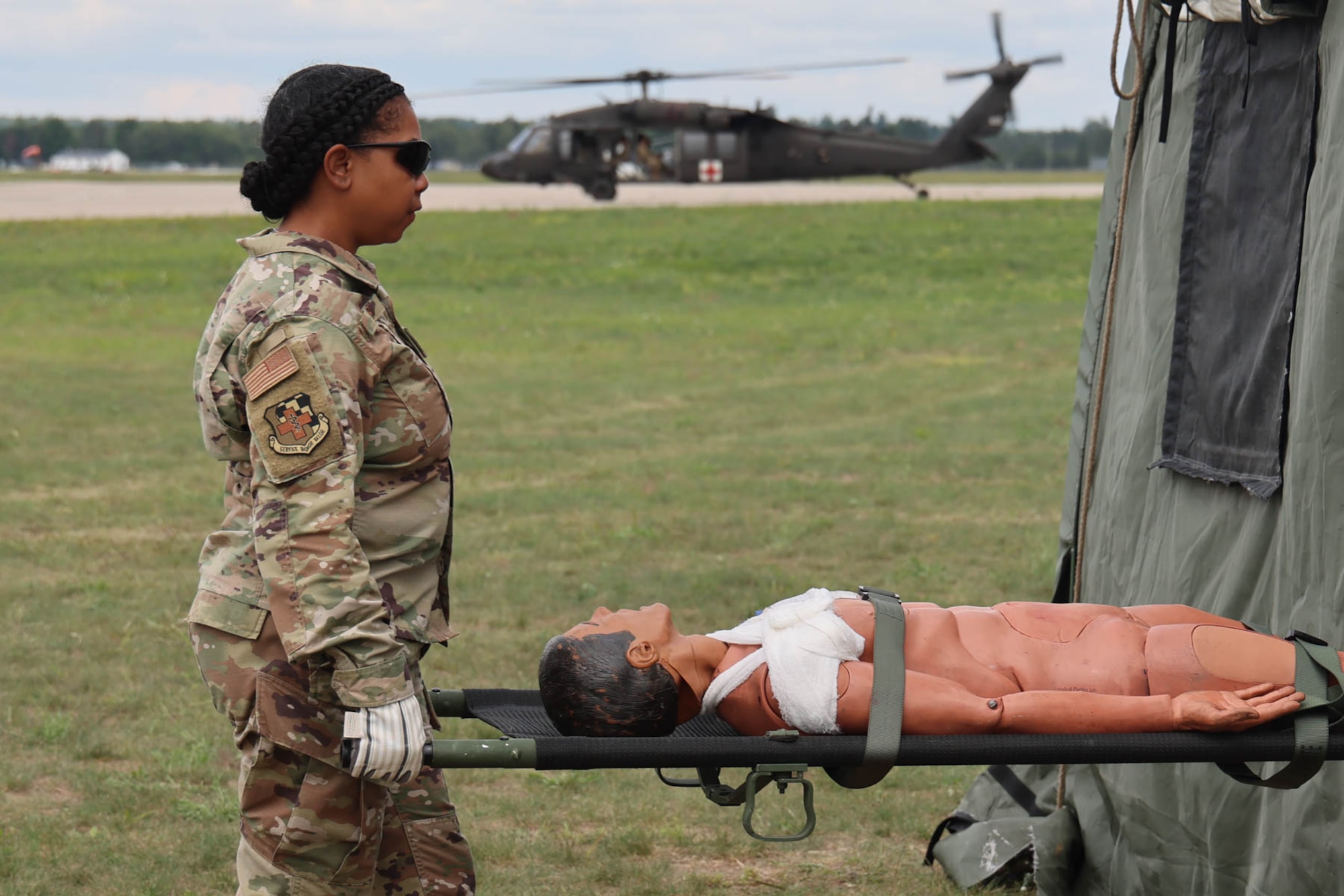 Master Sgt. Sharmaine Hicks, aerospace medical technician from the 127th Wing Medical Group, Michigan Air National Guard, offloads a practice patient during joint medical training at Northern Strike 23. Training included exercising En Route Patient Staging System (ERPSS,) and Critical Care Air Transport Team (CCAT.) ERPSS is used for temporary staging, casualty care, and administration support during contingency operations, and is capable of sustaining 24-hour operations. Northern Strike is one of the National Guard’s largest joint, readiness producing exercises, held annually at Michigan’s National All-Domain Warfighting Center, which consists of Camp Grayling, the Alpena Combat Readiness Training Center, the Battle Creek Air National Guard Base, the Selfridge Air National Guard Base and other training areas. It is designed to challenge the training audience in many ways, including contested sustainment/logistics.