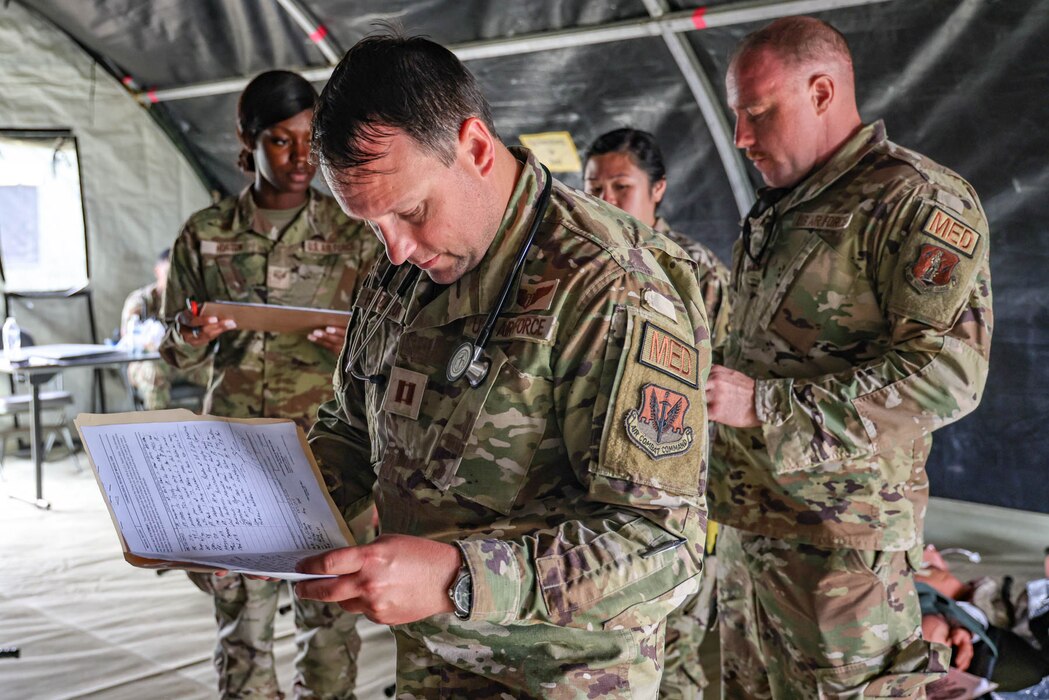 U.S. Air Force Capt. Chris Hanczaruk, a flight doctor from the Michigan National Guard’s 127th Medical Group, simulates staging patients before medical evacuation during an Exercise Northern Strike 23 joint medical training event at the Grayling Army Air Field, Grayling, Michigan, Aug. 14, 2023. NS23 is a premier reserve component training event that integrates both U.S. and partner nation readiness training to build interoperability and strengthen partnerships in an all-domain environment. (U.S. Air National Guard photo by Tech. Sgt. Andrew Schumann)