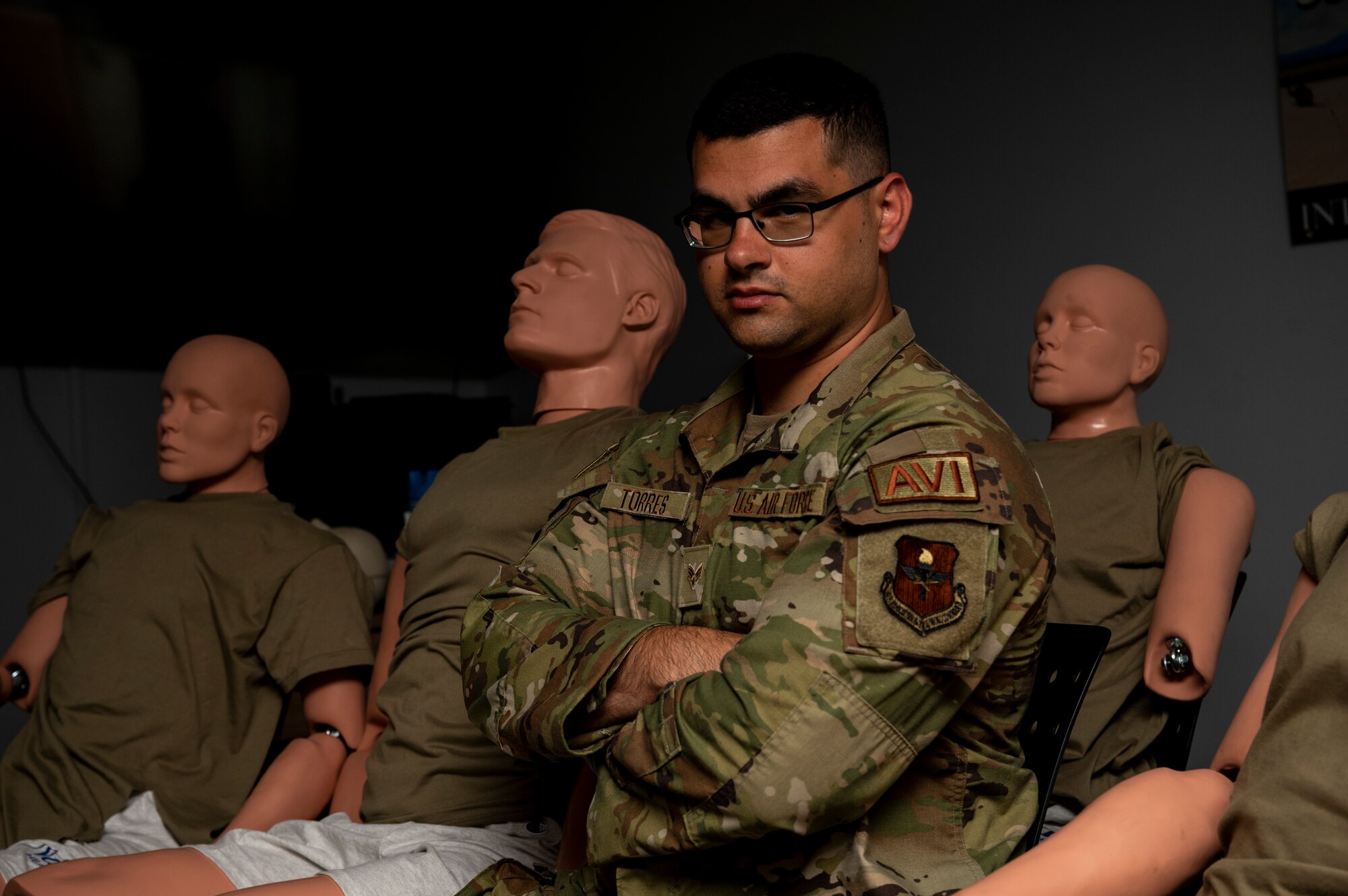 Man poses for photo with mannequins