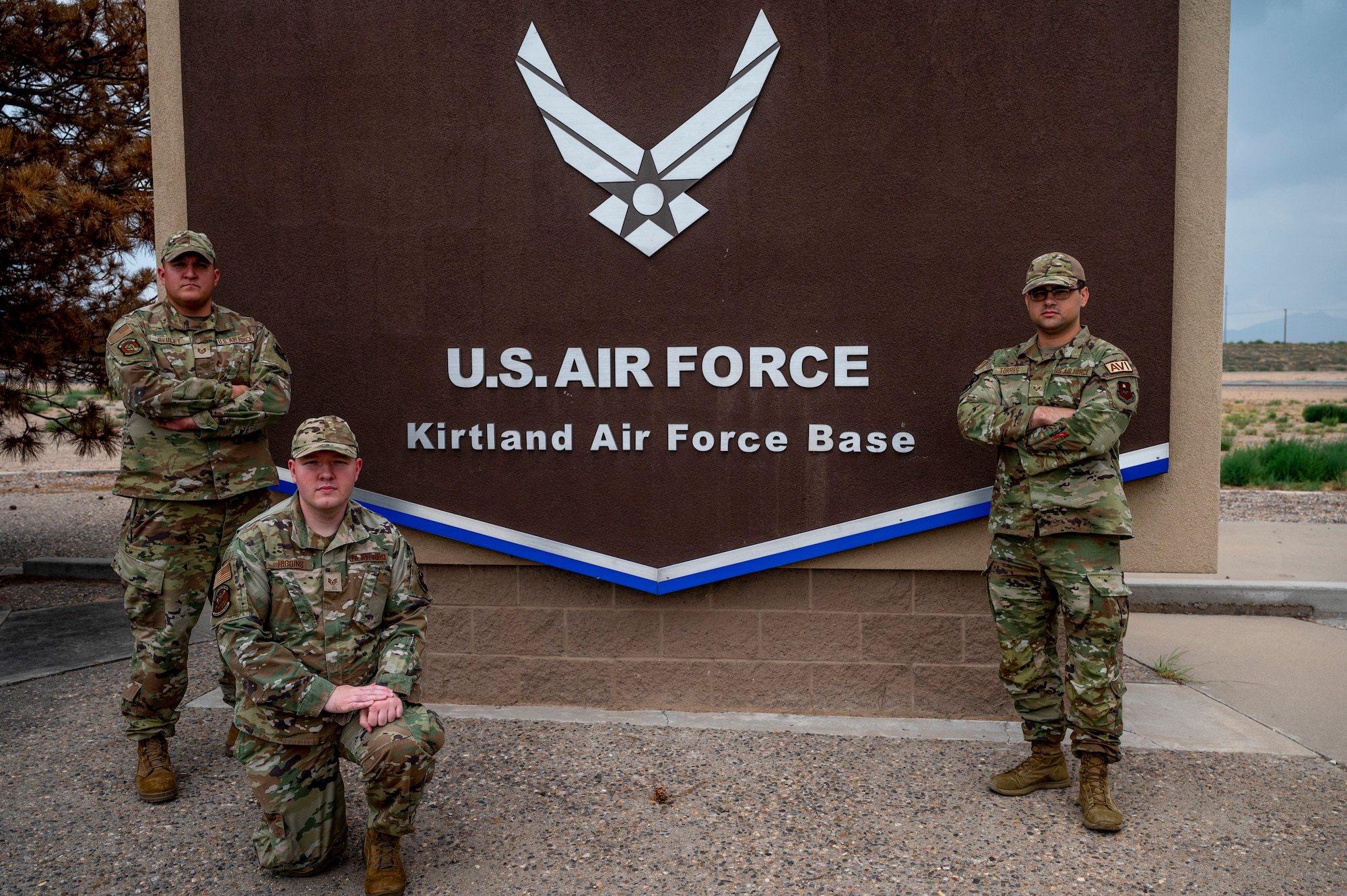 Group poses in front of Kirtland AFB sign