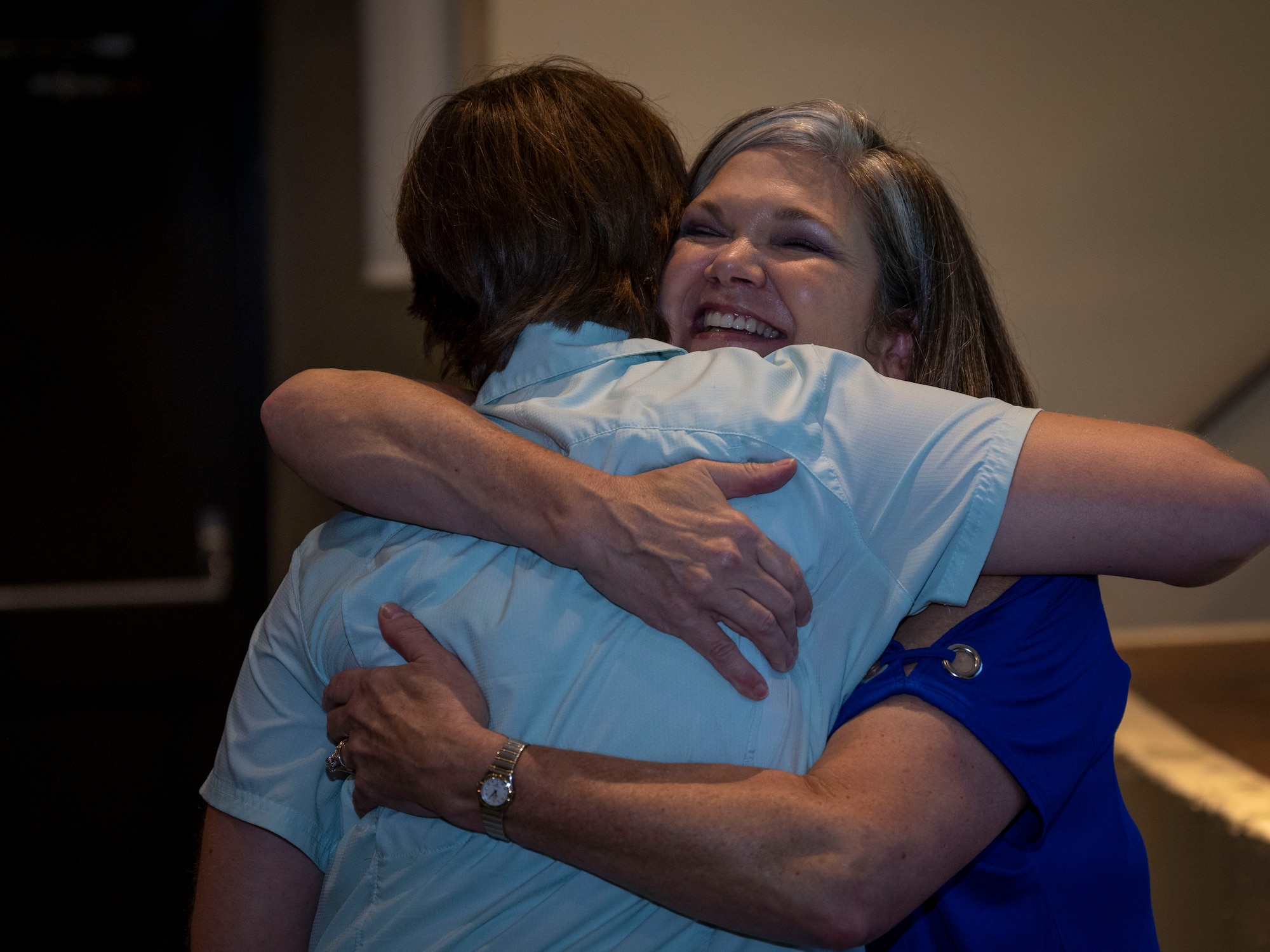 Kristen Christy, right, an international resilience expert, hugs and Airman assigned to the 4th Fighter Wing after conducting a resiliency chat at Seymour Johnson Air Force Base, North Carolina, Aug. 29, 2023. Christy was recognized as the Air Force Spouse of the Year in 2018 and as one of the top 30 women military influencers in 2019. (U.S. Air Force photo by Senior Airman David Lynn)