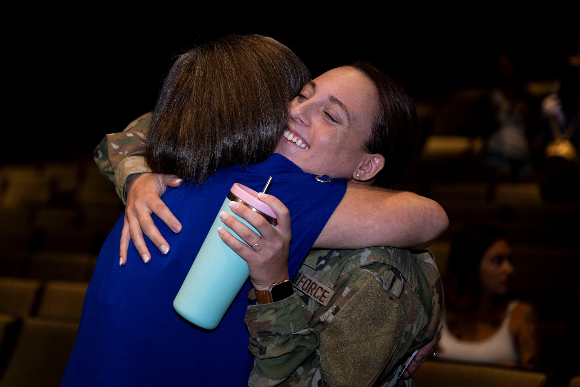 Kristen Christy, left, an international resilience expert, hugs and Airman assigned to the 4th Fighter Wing after conducting a resiliency chat at Seymour Johnson Air Force Base, North Carolina, Aug. 29, 2023. Christy was recognized as the Air Force Spouse of the Year in 2018 and as one of the top 30 women military influencers in 2019. (U.S. Air Force photo by Senior Airman David Lynn)