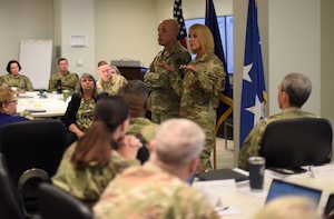Image of a group of Airmen talking at a conference.