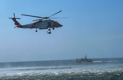 U.S. Coast Guardsmen from U.S. Coast Guard Station New Orleans hoist an Airman from the water to an MH-60 Jayhawk during a simulated search and rescue mission in Gulfport, Mississippi, July 19, 2023. The 183rd Aeromedical Evacuation Squadron conducted annual training with the 189th Medical Group, Arkansas ANG, and U.S. Coast Guardsmen from Gulfport and New Orleans.