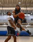 A Minot Airman gets into position to make a layup during the Summer Games at Minot Air Force Base, North Dakota, Aug. 25, 2023. The 5th Force Support Squadron hosts the annual Summer Games to encourage physical fitness, camaraderie and competition. (U.S. Air Force photo by Airman 1st Class Kyle Wilson)