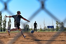 An Airman participating in the 2023 Summer Games at Minot Air Force Base, North Dakota, kicks a ball during the Kickball tournament Aug. 25, 2023. The annual Summer Games are put on by the 5th Force Support Squadron to promote physical health, camaraderie and competition. (U.S. Air Force photo by Senior Airman Zachary Wright)