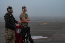 Two 5th Bomb Wing crew chiefs perform the morning's pre-flight routines on a B52-H Stratofortress at Minot Air Force Base, North Dakota, Aug. 24, 2023. It’s the responsibility of crew chiefs to ensure that every component of these high performance aircrafts are maintained to precise standards. (U.S. Air Force photo by Airman 1st Class Alexander Nottingham)