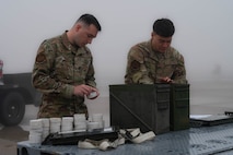 Senior Airman Chase Melies and Airman 1st Class Trevor Sexton, 5th Munition squadron members, load munition starter cartridges at Minot Air Force Base, North Dakota, Aug. 24, 2023. It's the responsibility of 5 MUNS to assemble and process nonnuclear munitions. Working with a high level of attention to detail and extreme care, these experts handle, store, transport, arm and disarm weapons systems to ensure the safety of our Airmen and the success of our missions. (U.S. Air Force photo by Airman 1st Class Alexander Nottingham)