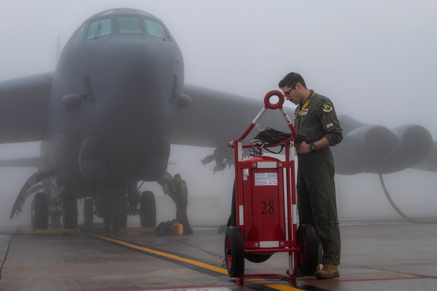 Capt. Nicholas Donato, 69th Bomb Squadron pilot, checks on the preflight binder before the day's mission at Minot Air Force Base, North Dakota, Aug. 24, 2023. Aircrew members are experts in knowledge of theory of flight, air navigation, meteorology, flying directives, aircraft operating procedures and mission tactics. (U.S. Air Force photo by Airman 1st Class Alexander Nottingham)