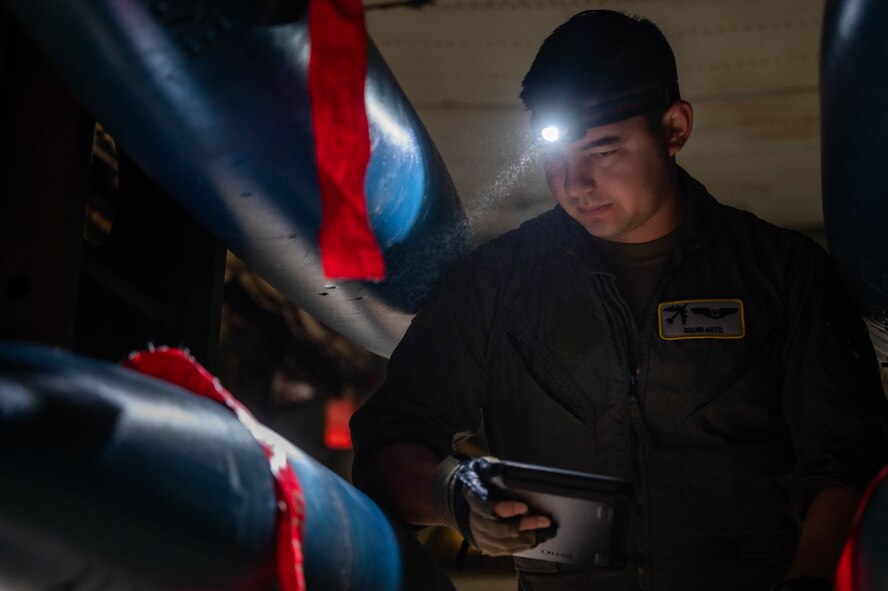 Capt. David Aoto, 69th Bomb Squadron aircrew, checks the training munition, which sits loaded in the bomb bay of a B52-H Stratofortress at Minot Air Force Base, North Dakota, Aug. 24, 2023. During Desert Storm, B-52s delivered 40 percent of all the weapons dropped by coalition forces. (U.S. Air Force photo by Airman 1st Class Alexander Nottingham)