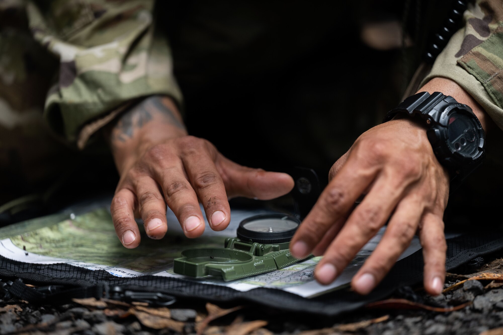 A Ranger Assessment Course student practices land navigation during the RAC, May 23, 2023, Schofield Barracks, Hawaii. While going through the Ranger Assessment Course, the students learned skills such as battle drills, land navigation, and small unit tactics like ambushes which ultimately led to an understanding of combat leadership, followership, troop leading procedures, communication skills, accountability, performance under stress, intestinal fortitude and much more. (U.S. Air Force photo by Tech. Sgt. Hailey Haux)