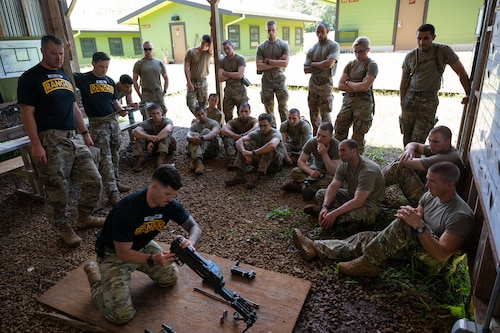 Ranger Assessment Course students learn how to take apart and name the main components of different weapons systems, May 29, 2023, Schofield Barracks, Hawaii. Truly representing a joint force, there were service members from numerous Air and Space Force Specialty Codes and Army Military Occupational Specialties in the RAC. It ranged from Army infantry to Air Force medics and Space Force developmental engineer and included career fields like engineer officer, military police, contracting, security forces and others. (U.S. Air Force photo by Tech. Sgt. Hailey Haux)
